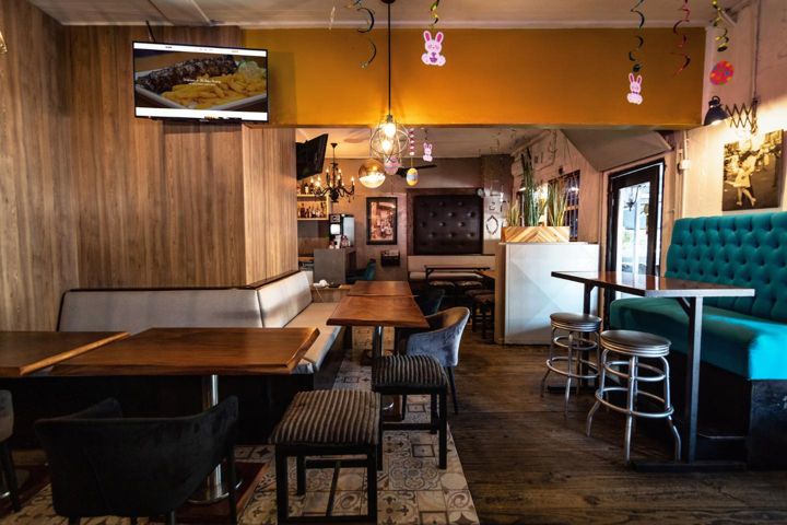 Vintage dining room with mustard walls and teal tufted booths