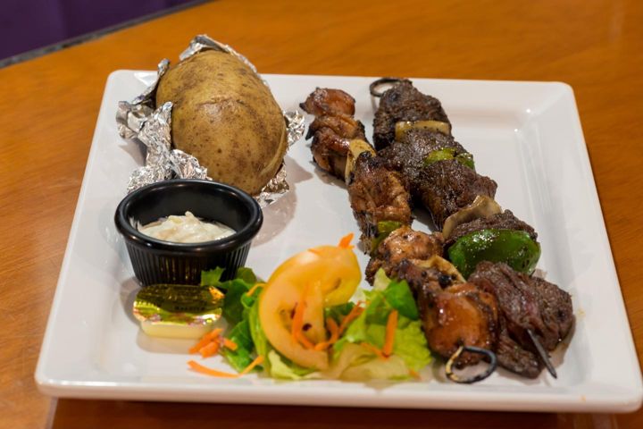 Lomito and chicken skewers with baked potato